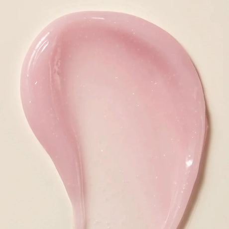 Axis-Y Calamine Pore Control apsule Serum texture reference. The serum is of a light pink gel consistency with tiny capsules in it.